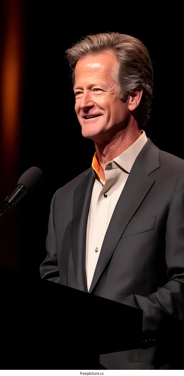 Man in Suit Speaking at a Conference with a Microphone
