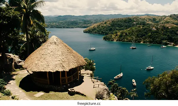 Tropical Hut Overlooking a Bay with Sailboats