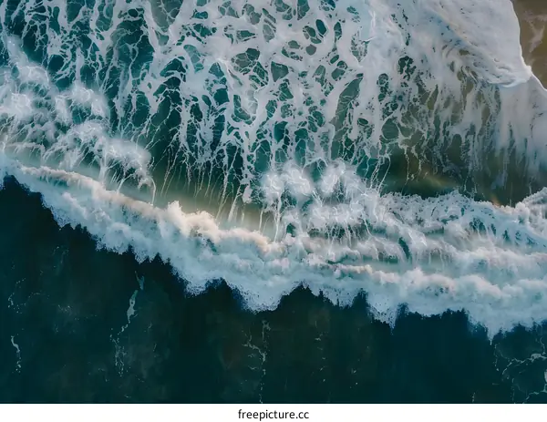 Aerial View of Ocean Waves Crashing on the Beach