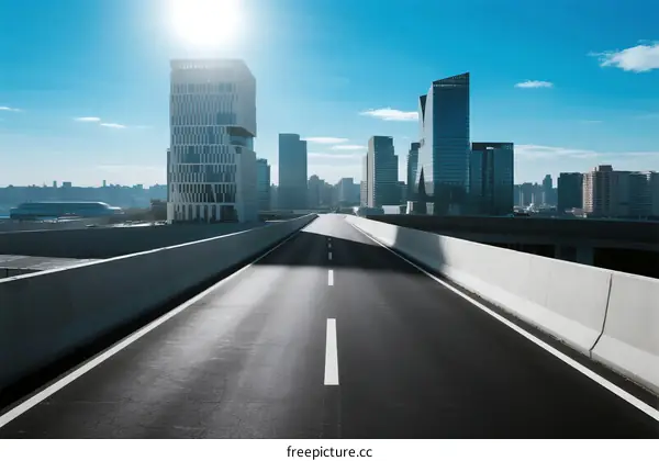 Modern city road with tall buildings under clear blue sky