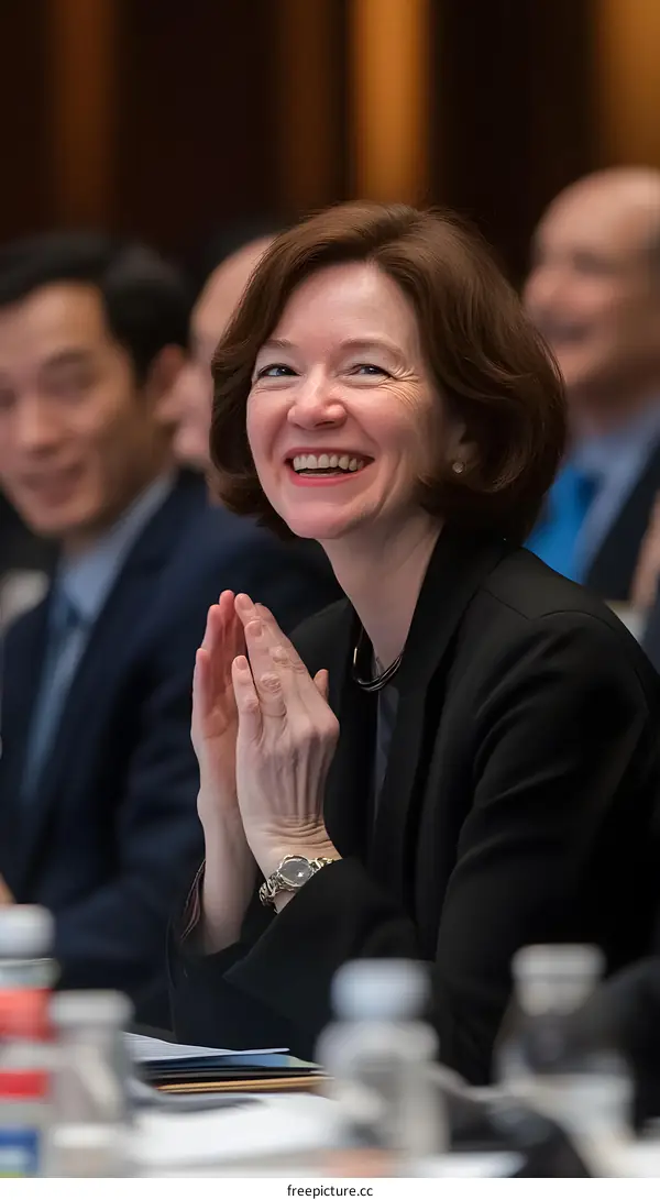 Woman Clapping During Meeting in Conference Room