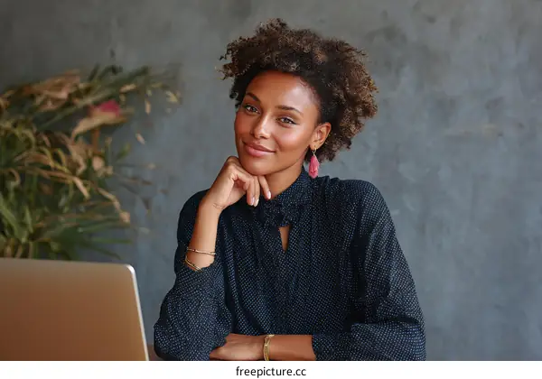 Professional woman in casual business attire working on laptop