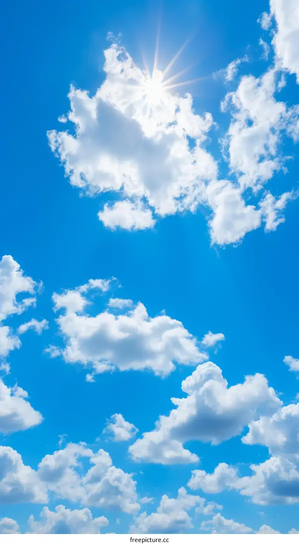 Sunbeams Through White Clouds in a Blue Sky