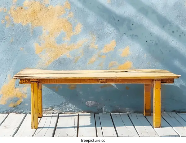 Rustic Wooden Bench Against Weathered Blue Wall