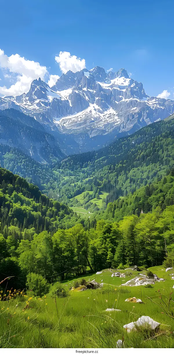 mountain range with green valley and blue sky