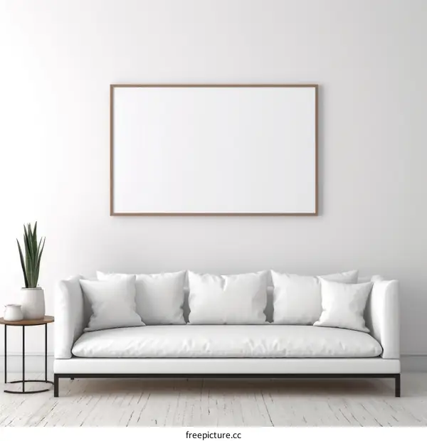White sofa in front of blank wall with plant and table