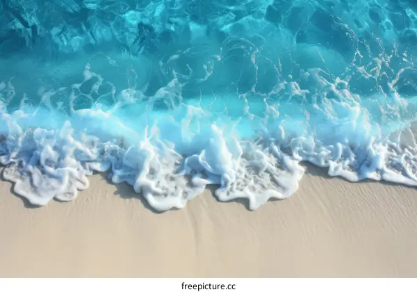 Blue and white ocean waves crashing on a sandy beach