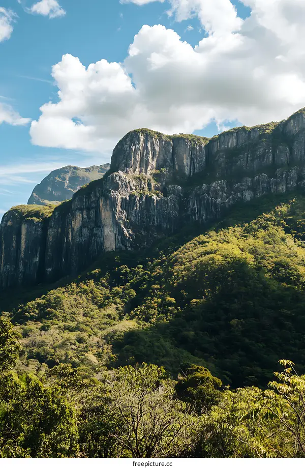 Dramatic Mountain Landscape with Lush Green Foliage and Clouds