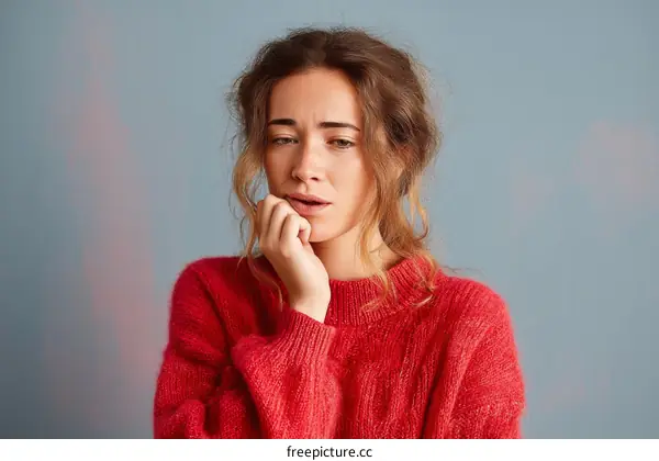 Woman in Red Sweater Expressing Anxiety