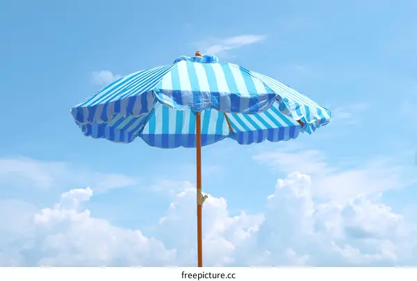 Striped Beach Umbrella Against a Blue Sky