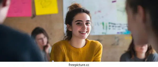 Smiling Young Woman in a Group Meeting