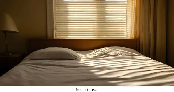 Bedroom with White Bed and Blinds