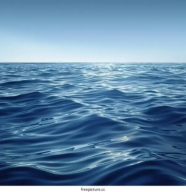 Deep blue ocean surface with sunlight reflecting off the waves