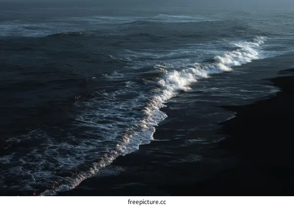 Dark Sea Waves Crashing on Black Sand Beach