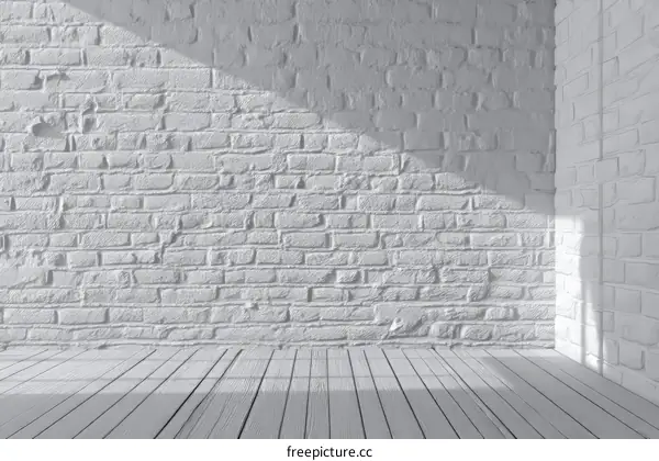Empty room with white brick wall and wooden floor