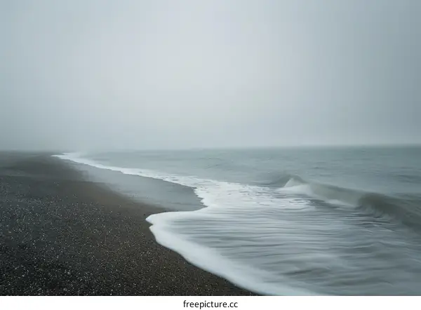 Black Sand Beach with Calming Waves and Pure White Foam