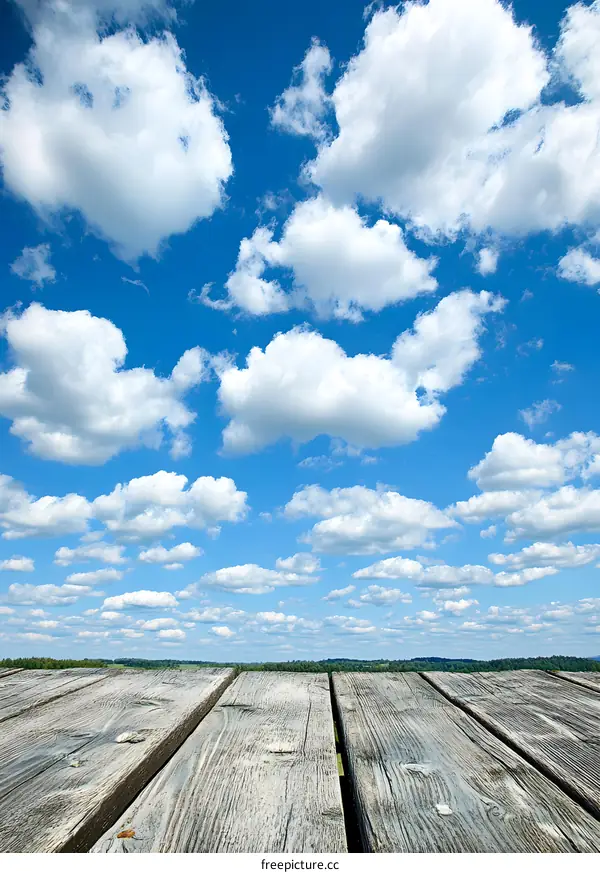 Wooden Planks Under Blue Sky With White Clouds