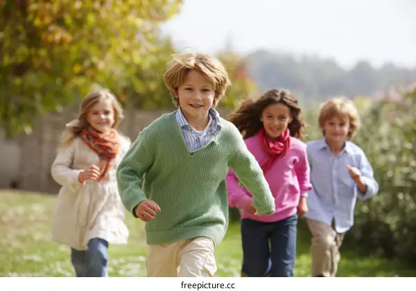 Children Running Outdoors in Autumn