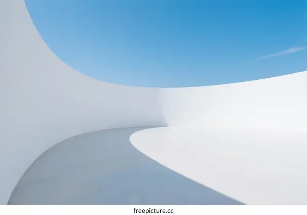 Minimalist Curved White Architecture with Clear Blue Sky