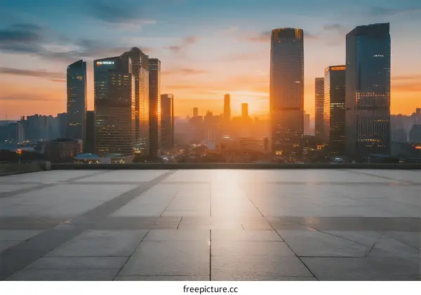 Sunset view of modern city skyscrapers with empty square
