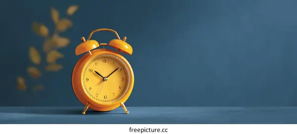 Classic Yellow Alarm Clock on a Blue Background