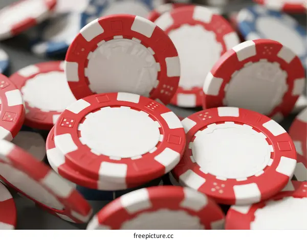 Pile of red and white poker chips on gray surface