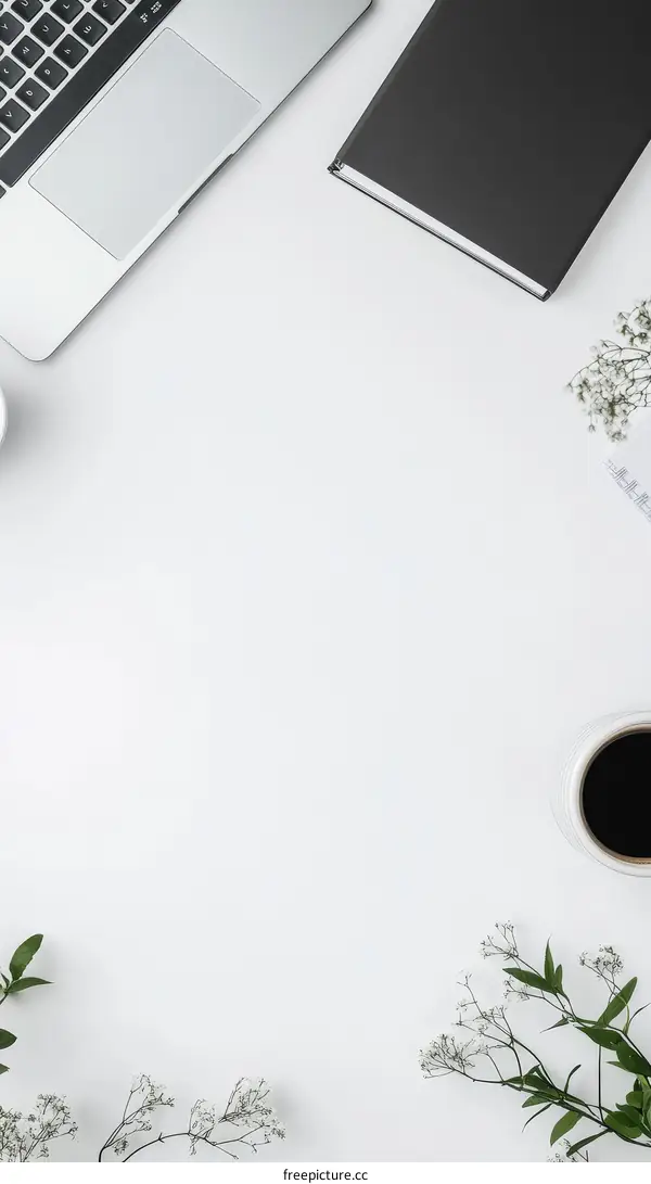 Minimalist Workspace with Laptop and Notebook