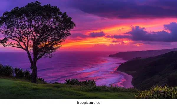 Vibrant Sunset Over the Ocean with Coastal Landscape