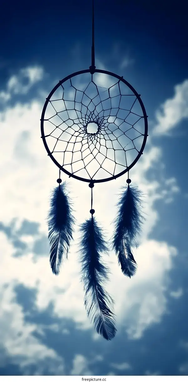Dreamcatcher Hanging Against Cloudy Sky