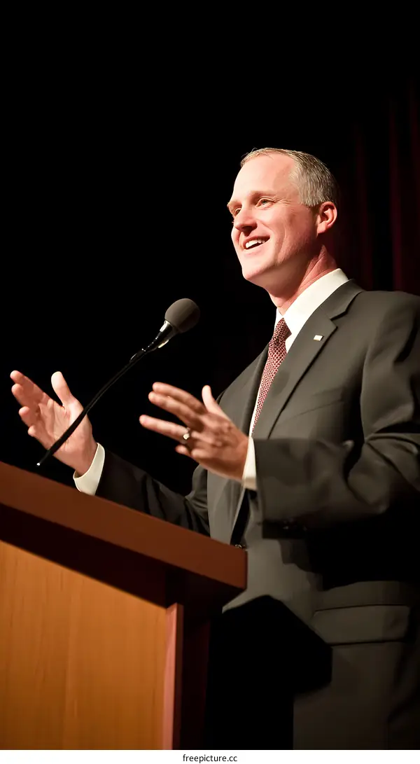 Man Speaking at Podium with Microphone