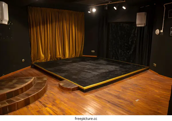 Empty Stage with Golden Curtains and Wooden Floor
