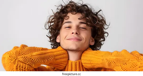 Portrait of a Young Man with Curly Hair Wearing a Yellow Sweater