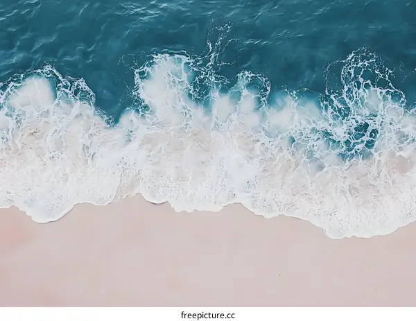 Aerial View of Ocean Waves Crashing on Sandy Beach