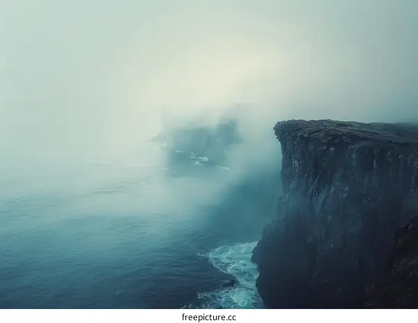 Foggy cliffs rising out of the sea