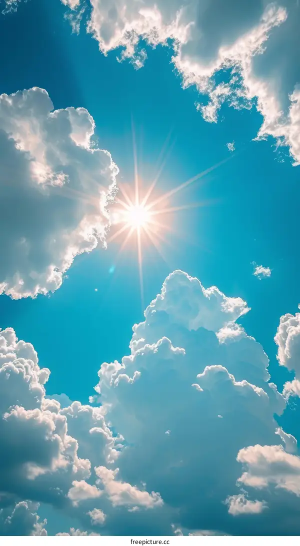 Cumulus cloudscape with sunbeams bursting through