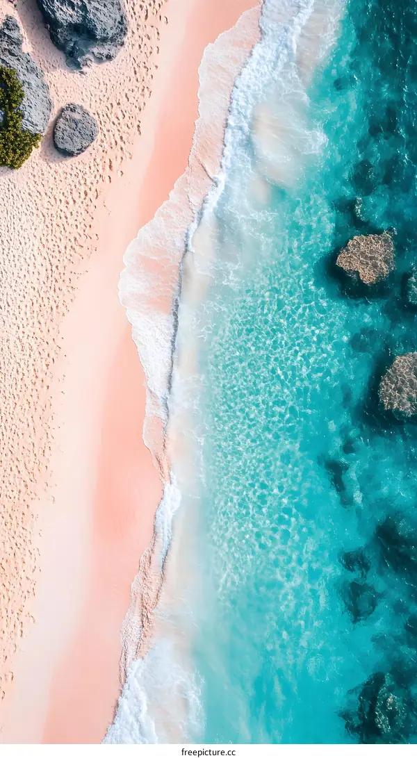 Aerial View of Turquoise Ocean Water Meeting Pink Sandy Beach