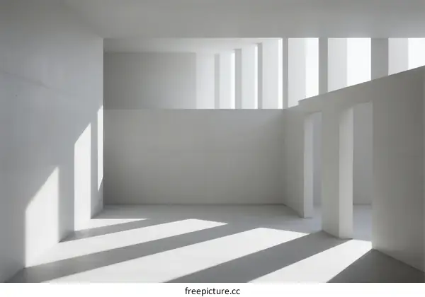 Minimalist white interior space with natural light coming through windows