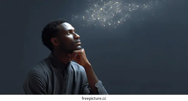 A man thinking with glowing particles representing ideas above his head