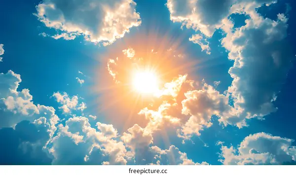 Sun Shining Through Clouds in Blue Sky