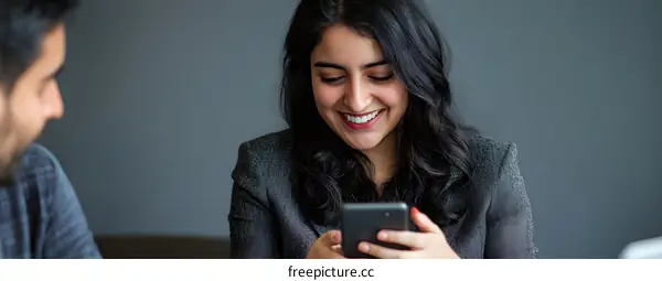 Smiling Woman Looking At Her Phone