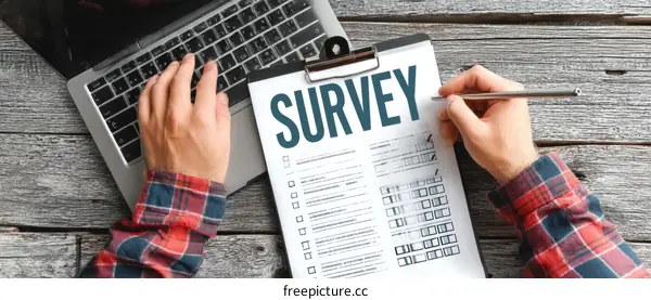 Survey Form on Wooden Table with Laptop