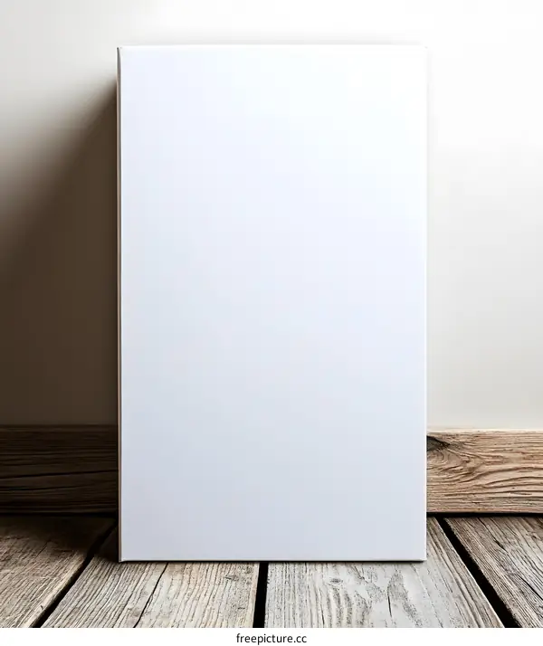 Blank White Canvas on Wooden Floor