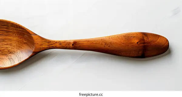 A wooden spoon with a long handle.