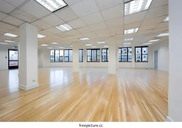 Empty Office Space with Wood Floor and Windows