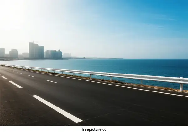 Smooth highway along the coastal city with clear blue sea
