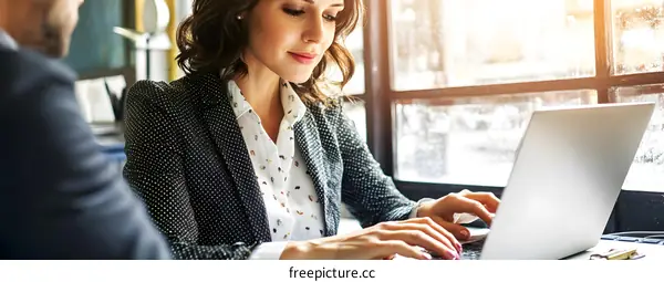 Woman Typing on Laptop in a Cafe