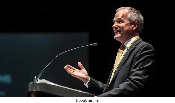 Man Giving Speech At Podium With Microphone