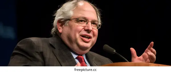 Man in Suit Speaking at a Conference