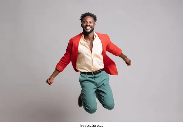 Stylish African Man Jumping in Fashionable Outfit