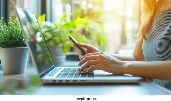 Woman Working on Laptop and Mobile Phone